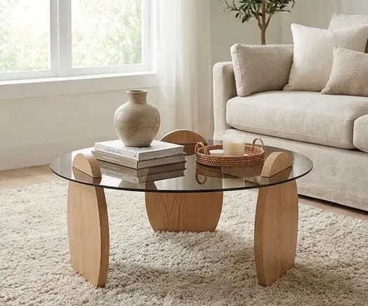 Glass coffee table with wooden legs in a living room setting