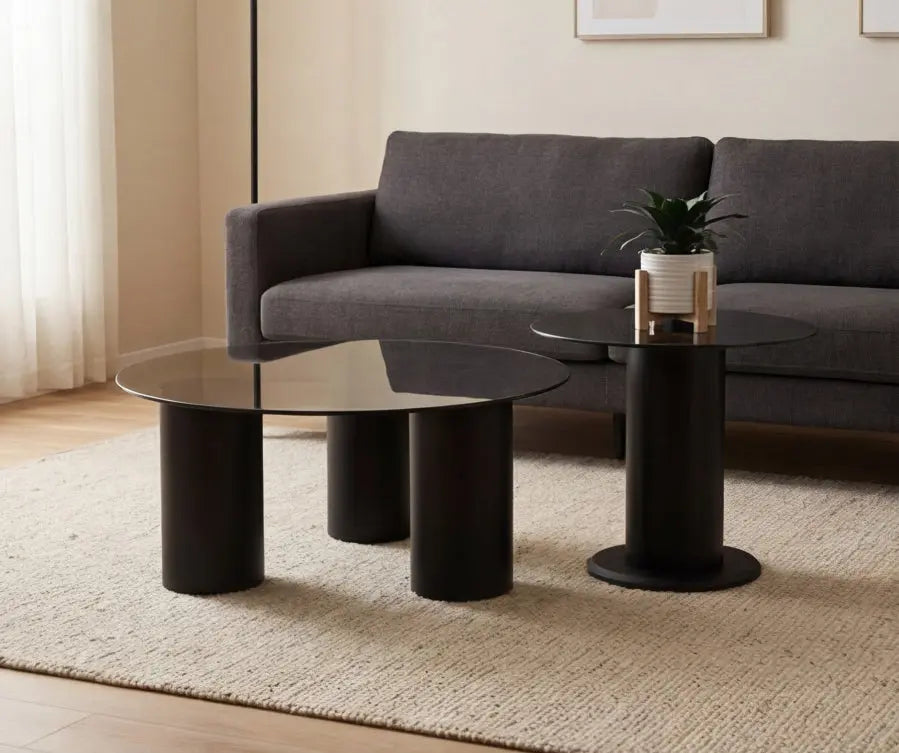 Modern living room with a gray sofa and black coffee tables.