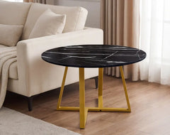 Round black marble coffee table with yellow legs in a living room setting.