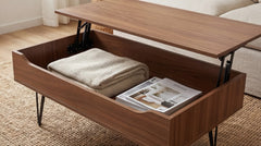 Wooden coffee table with lift-top design, revealing storage space with a blanket and magazine.