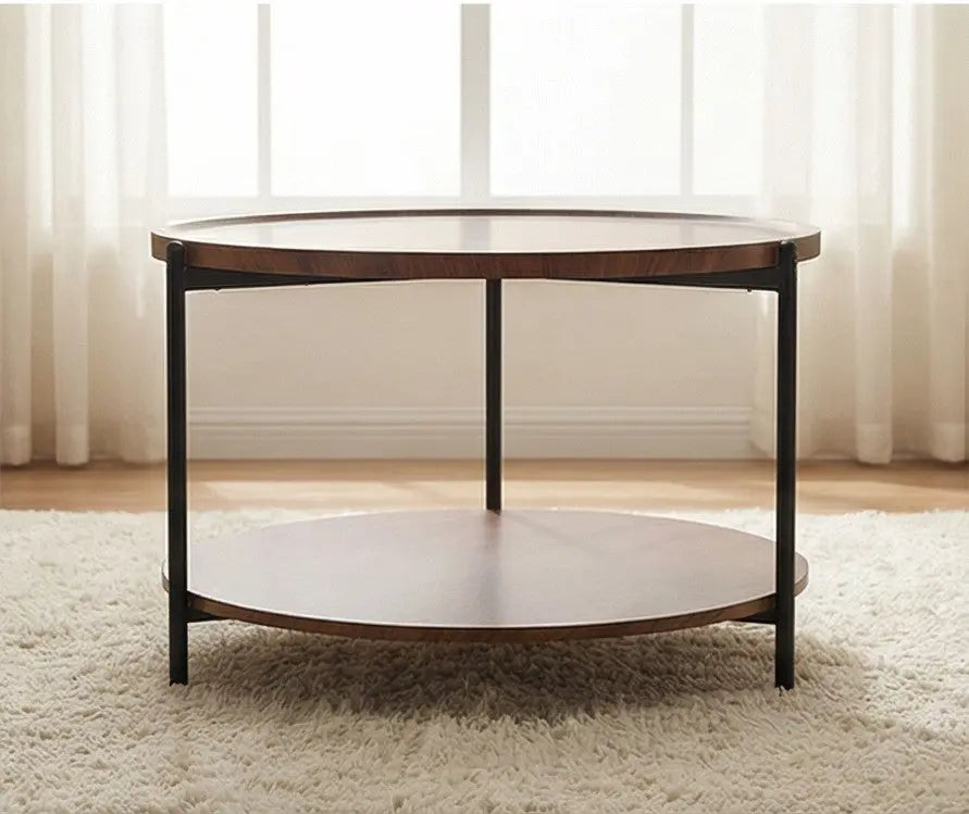 Round wooden coffee table with a white shelf in a room with light curtains.